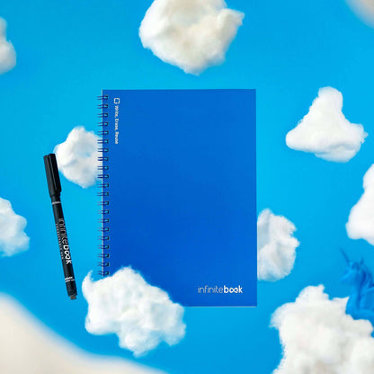 Infinitebook Plain A5 Blue reusable notebook with its black 0.6 mm marker on a sky-blue background with clouds